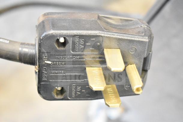Power plug for SaniServ W5273P ice cream machine, features three gold contact prongs. Labeled 50A, 125/250V.