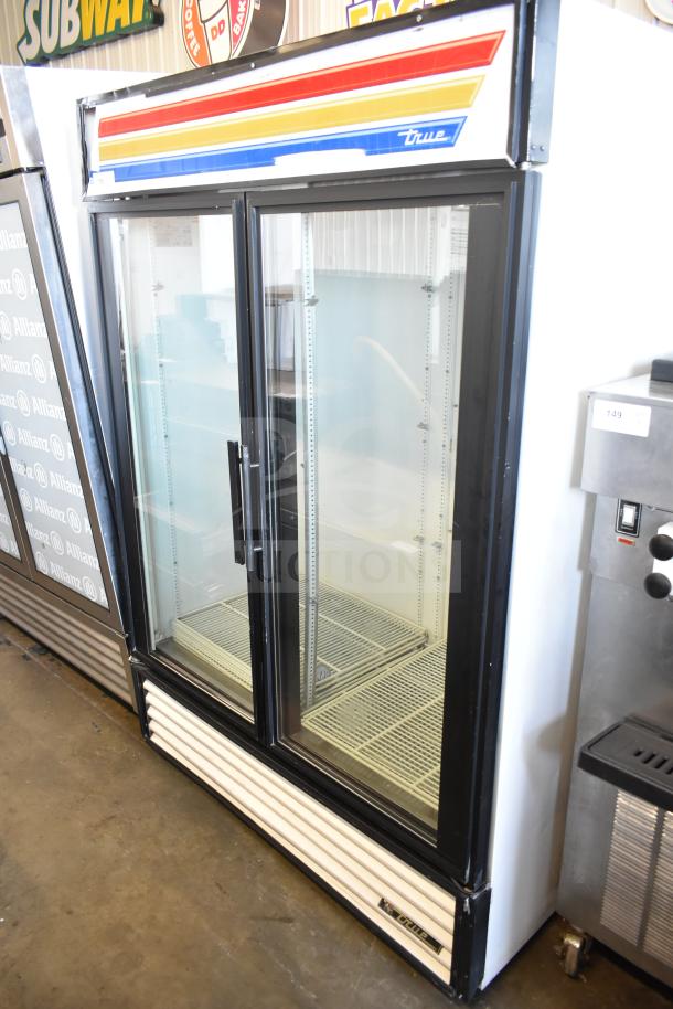 True GDM-49 commercial 2-door cooler, 115 volts, excellent condition with branding stripe. Two glass doors, spacious interior.