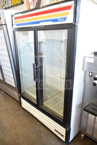 True GDM-49 commercial 2-door cooler, 115 volts, excellent condition with branding stripe. Two glass doors, spacious interior.