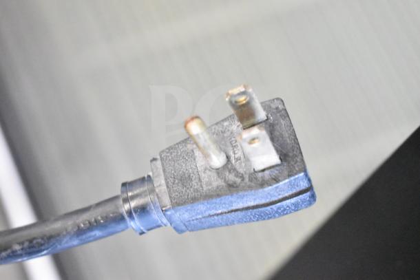 Close-up of an electrical plug for the True GDM-49 Commercial 2 Door Cooler, showing prongs and connection details.