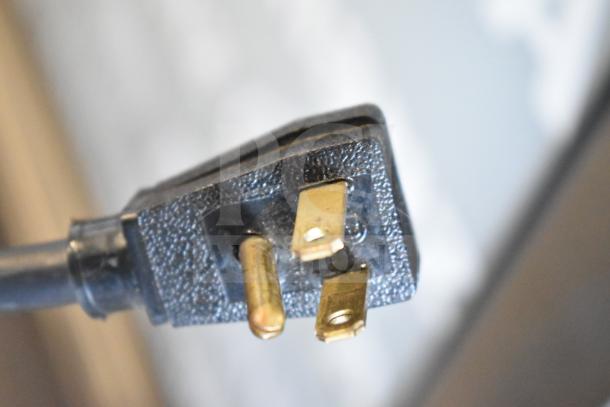 Close-up of a power plug for a 2019 True T-49G-HC commercial cooler. 115 volts, 1 phase.