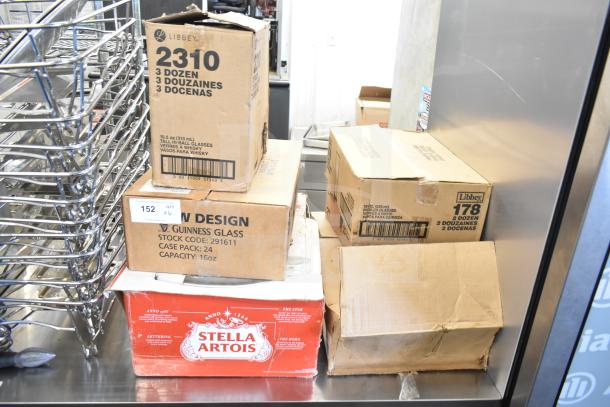Boxes of glasses including Libbey 2310 and 178, Guinness 16 oz., and Stella Artois packaging. Auction item lot of 6.