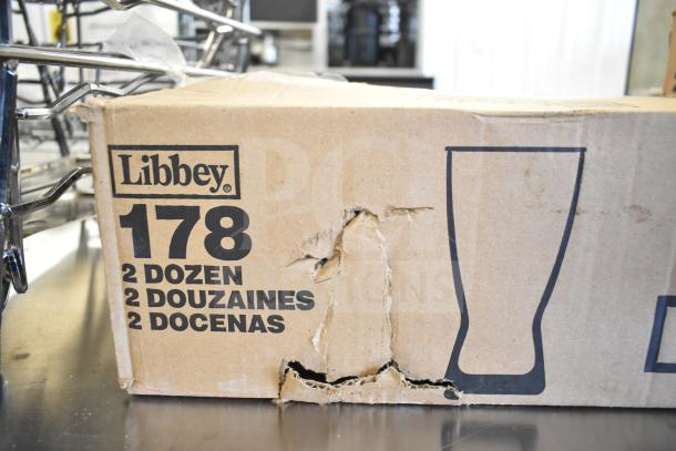 Damaged cardboard box labeled Libbey 178, containing 24 customizable 10 oz. pilsner glasses.