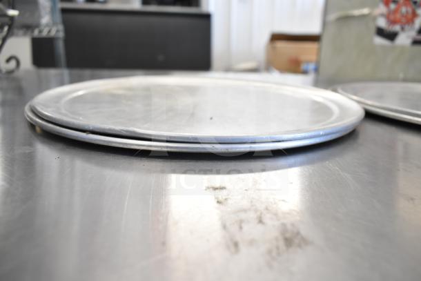 Metal chafing dish frames on a reflective surface, part of 15-item auction set. Used condition, functional for catering.