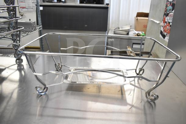 Stainless steel chafing dish frame with scroll design, part of a lot of 15 items. Good condition, ideal for catering.