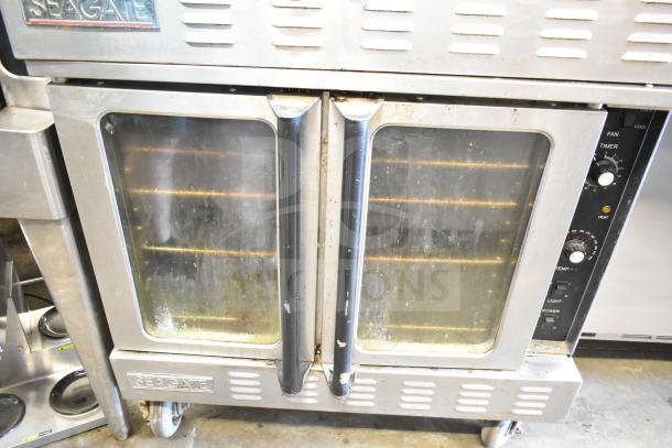 2 Seagate full-size convection ovens with view-through doors, thermostatic controls, on commercial casters. Used condition.