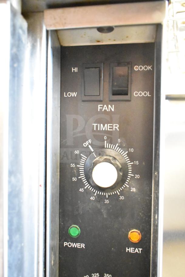 Seagate convection oven control panel with dials for fan speed, timer, and temperature, plus power and heat indicators.