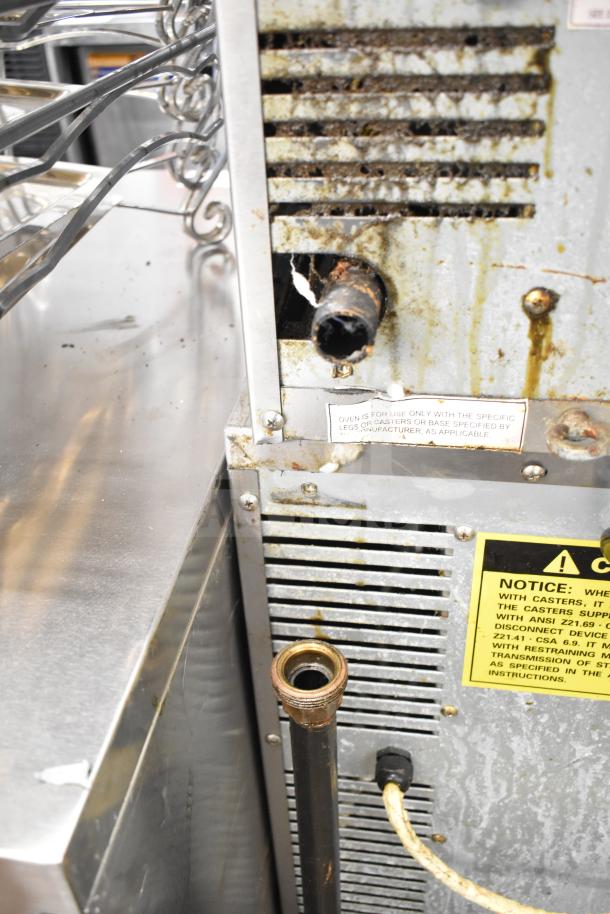 2 Seagate full-size convection ovens, with view-through doors, thermostatic controls, on commercial casters. Visible wear.