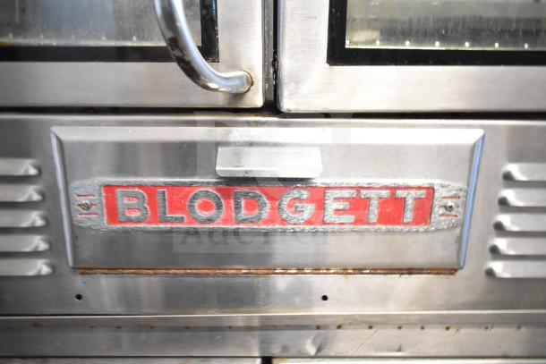 Blodgett commercial gas oven, stainless steel exterior, visible wear, prominent "BLODGETT" brand label on door.