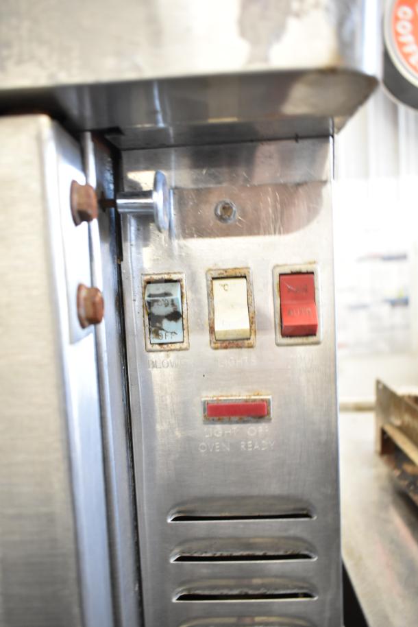 Blodgett commercial gas convection oven control panel; visible blower, lights, and auto switches. Slight wear on buttons.