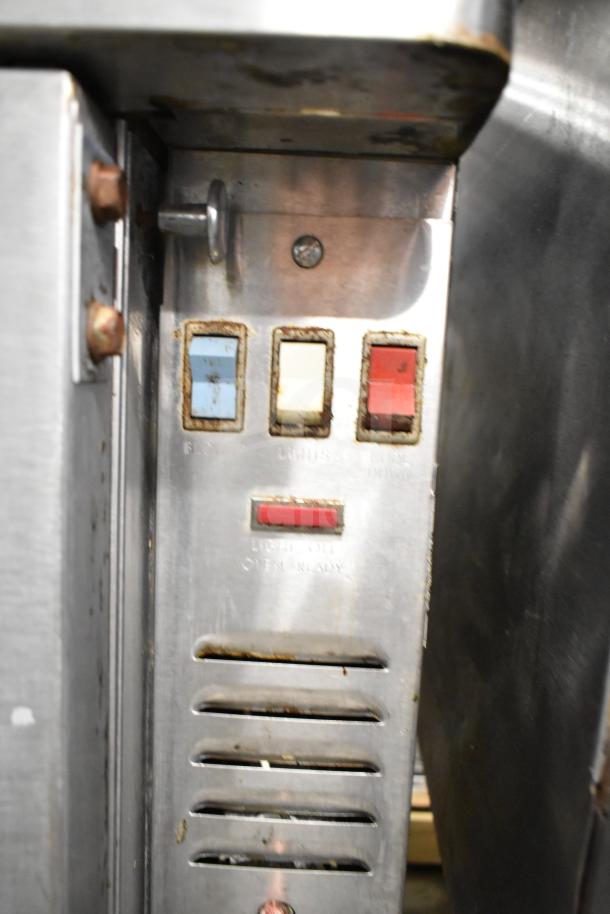 Blodgett commercial gas convection oven controls; shows buttons for light and power, indicating operational status.