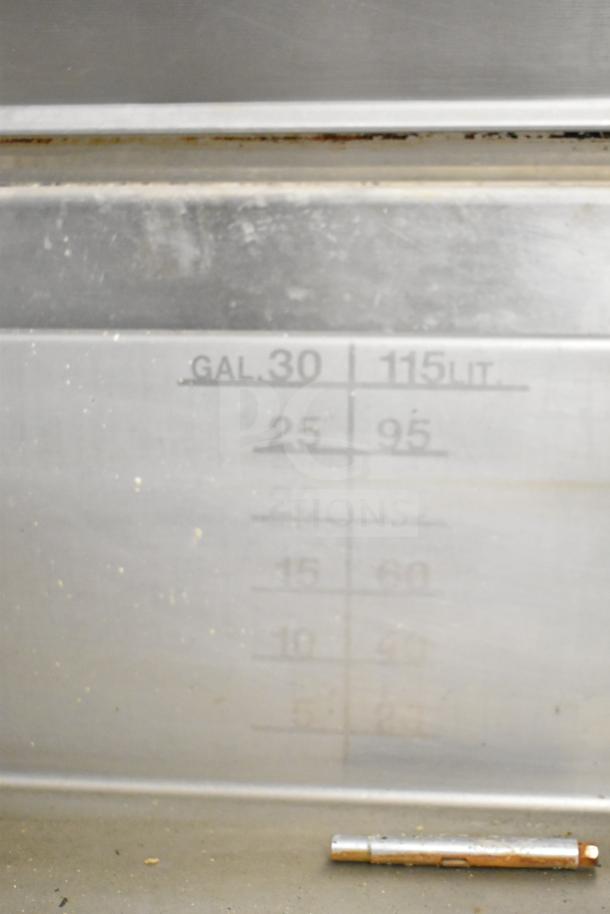Cleveland Commercial 30 Gallon Braising Pan with capacity markings in gallons and liters, stainless steel. Visible moderate wear.