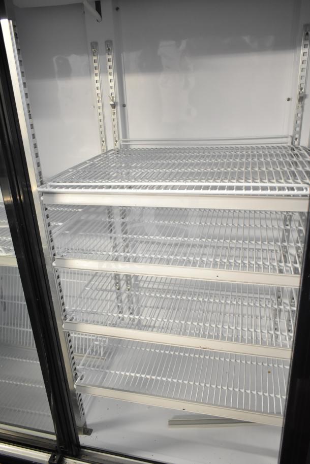 Dukers DSM-68SR three-door commercial cooler with adjustable wire shelves. Model DSM-68SR, in clean condition.