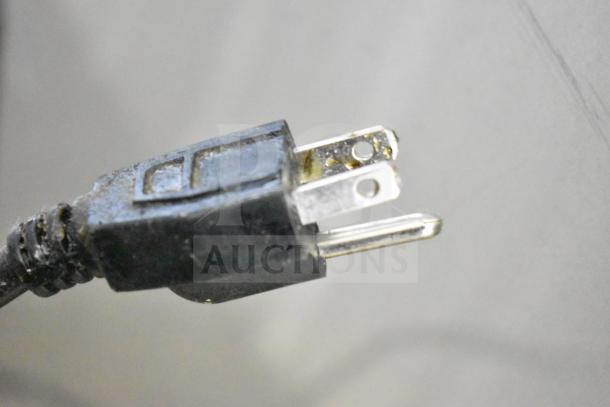 Close-up of a standard electrical plug on a Dukers DSM-68SR Commercial 3 Door Cooler Merchandiser, 115V, 1 Phase.