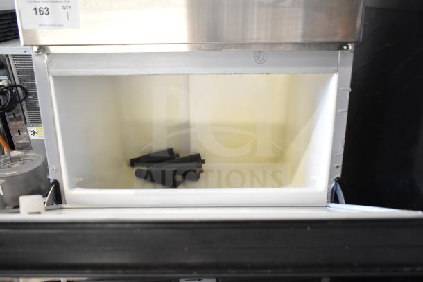 Hoshizaki commercial undercounter ice machine, 115 volts, 1 phase. Visible inside compartment with cone-shaped objects.