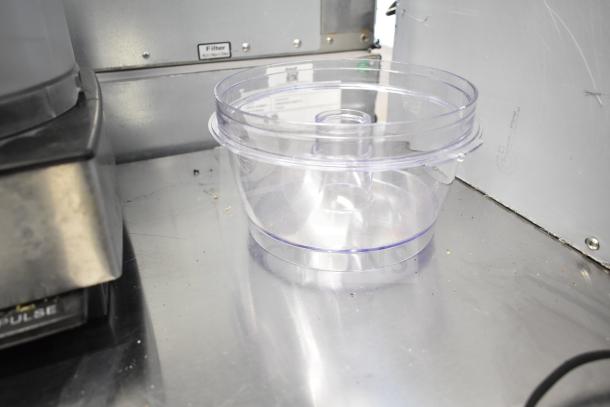 Cuisinart countertop food processor with clear bowl, black base, and visible control buttons. Includes 2 bowls and 1 S blade. 115V.