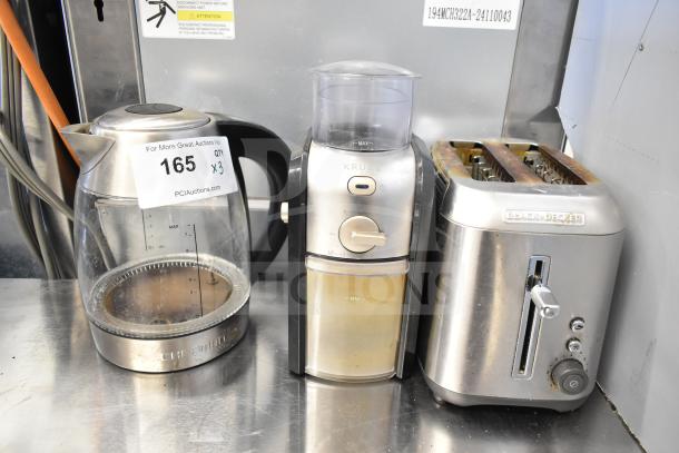 Three kitchen appliances: Black & Decker 2-slot toaster, Chefman hot water pitcher, Krups GVX212/6W0 grinder, used condition.