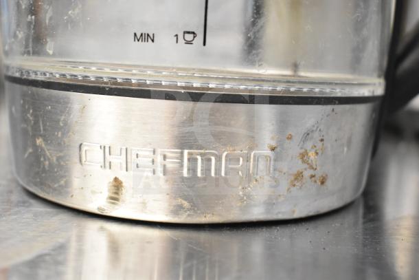 Chefman hot water pitcher base, stainless steel with visible wear. "Chefman" engraved. Minimum water level indicator.