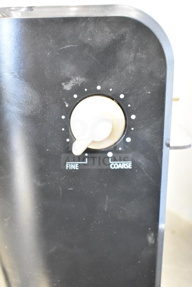 Black grinder with a control knob labeled "Fine" to "Coarse," part of a lot including Black & Decker toaster and Chefman pitcher.