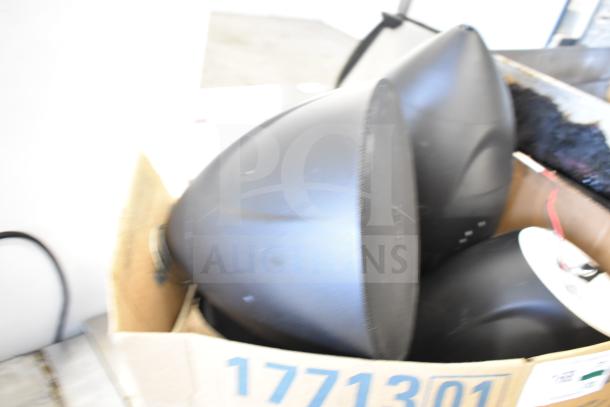 Box of 8 items, including QSC AD-S6T and Crestron speakers, visible tags with numbers, mixed condition.