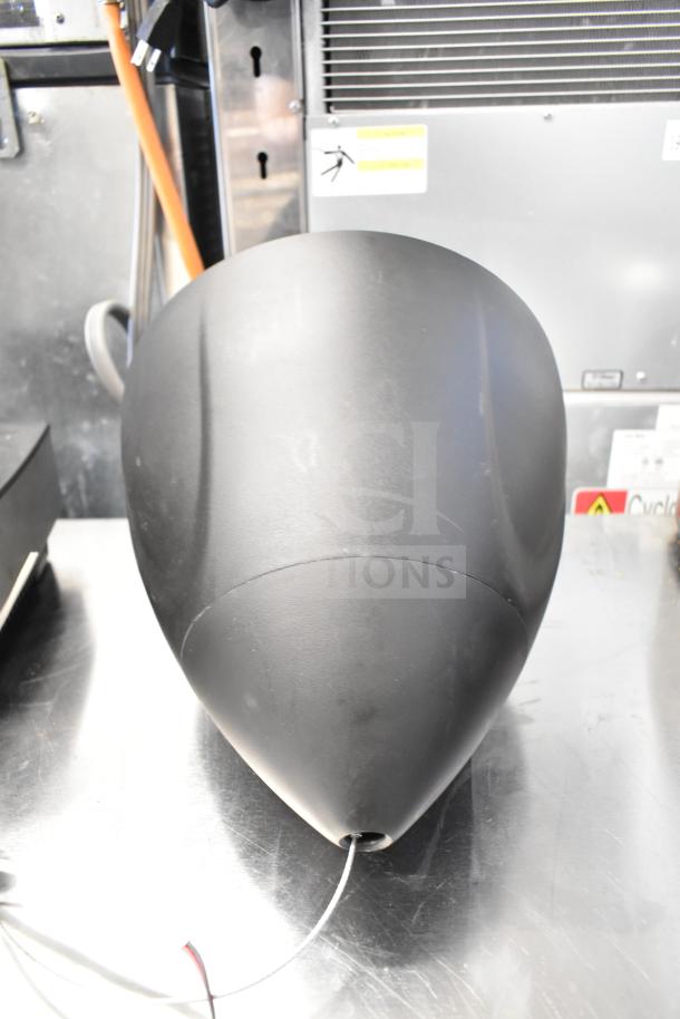 QSC AD-S6T speaker in black, cone-shaped design, featuring connection wires. Minimal wear, ideal for professional audio setups.