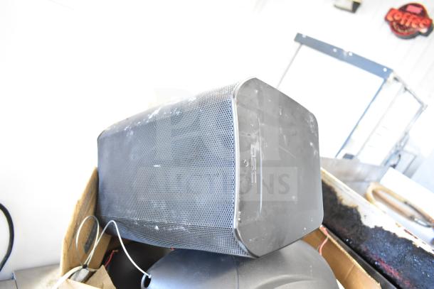 QSC AD-S6T speaker in used condition, featuring a black grille and visible wear. Includes Crestron speaker and six other items.