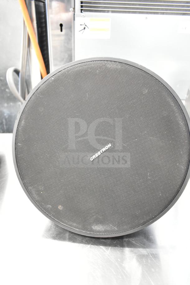 Crestron speaker with front grille, visible brand logo, and sleek design, part of an 8-item audio equipment auction.