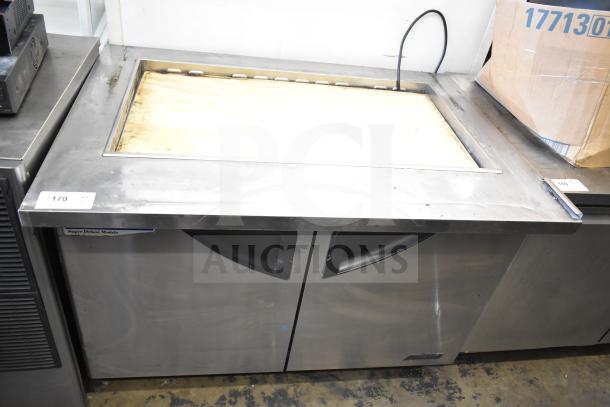 Turbo Air TST-48SD-18 prep table, stainless steel, two doors, 115 volts, labels visible, used condition.