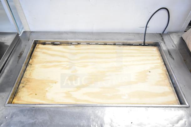 Turbo Air TST-48SD-18 prep table, stainless steel, 115V, 1 phase, empty top compartment, cable visible.