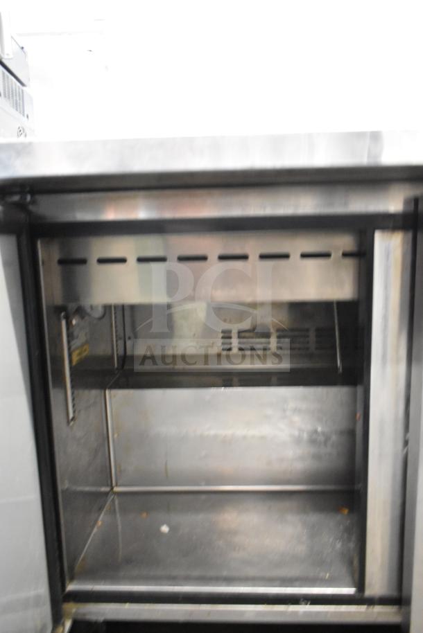Turbo Air TST-48SD-18 Prep Table in stainless steel; 115 volts, 1 phase. Interior view shows shelves, good condition.