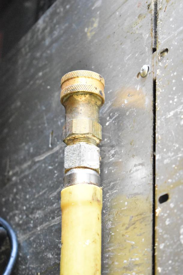 Close-up of a connector on a Garland Commercial Gas Powered Cheese Melter, showing metal and plastic components.