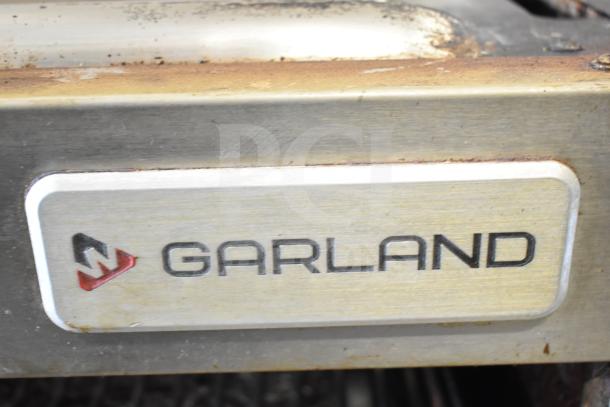 Garland commercial gas cheese melter in tarnished condition, featuring branded nameplate with logo.