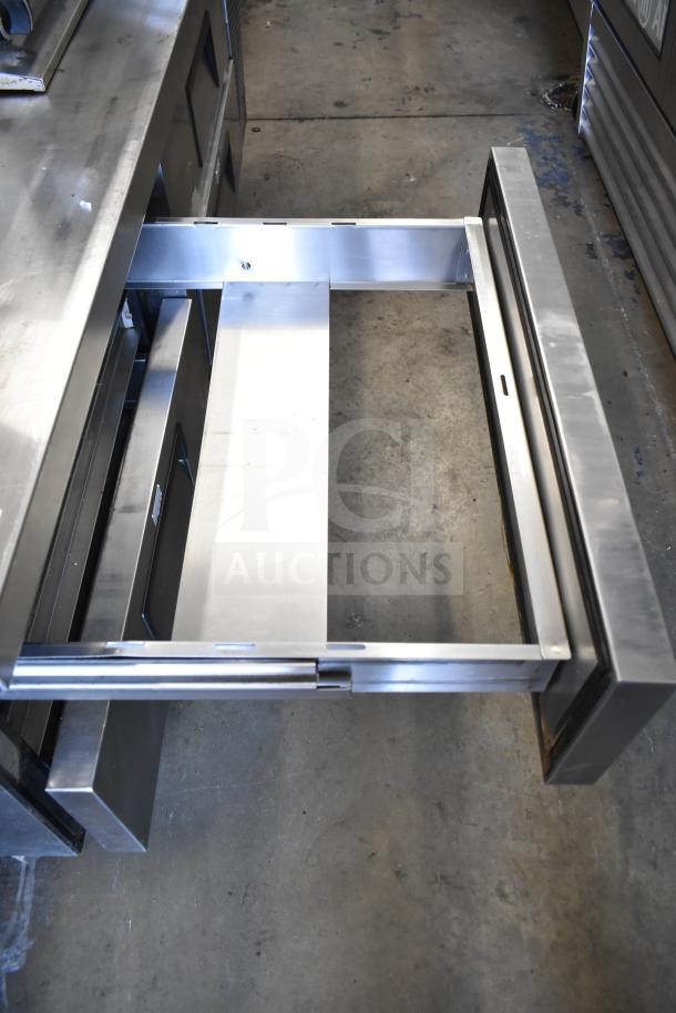 True TRCB-72 commercial chef base with 4 drawers open, features stainless steel finish, on commercial casters, 115 volts, 1 phase.