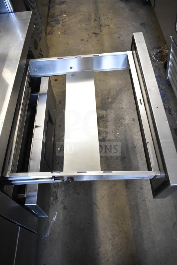 True TRCB-72 commercial chef base with 4 drawers, stainless steel, on commercial casters. 115V, 1 phase, visible internal drawer guides.