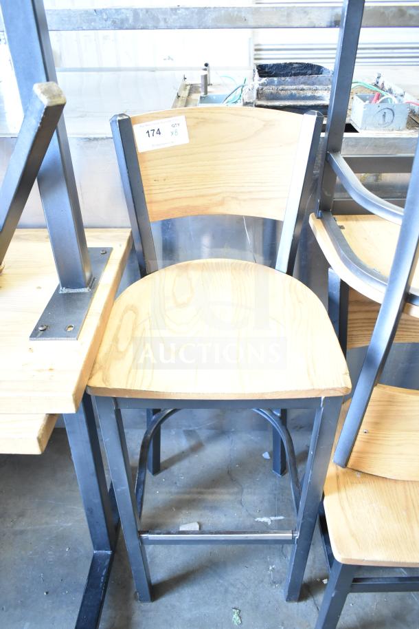 8 wood pattern dining and bar height chairs on metal frames. Quantity label shows "8 times your bid." Chairs appear in good condition.