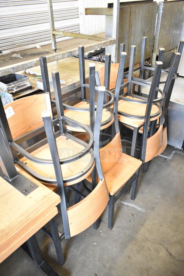 8 wood pattern dining and bar height chairs with metal frames, stacked, showing modern design and durability.
