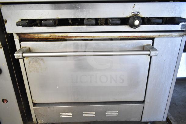 Commercial gas-powered 6 burner range with oven, over shelf, and backsplash; stainless steel, used condition.
