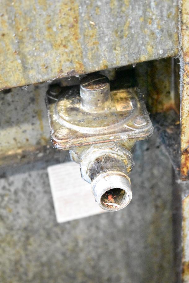 Commercial gas-powered 6 burner range with oven, featuring an over-shelf and backsplash. Appears used with visible wear.