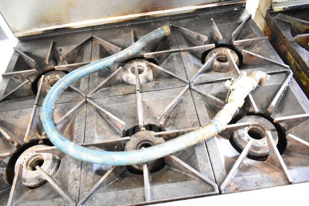 Vulcan 36S-6BN commercial gas range, six burners, visible wear, piping on burners, over shelf, and backsplash.