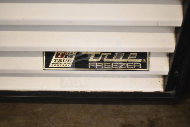 True GDM-49F Commercial Freezer, metal label displaying brand and model. Features two doors, 115/208-230V, 1 phase.