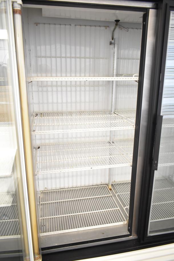 True GDM-49F commercial 2-door reach-in freezer merchandiser in used condition, featuring multiple wire shelves.