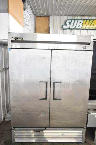 True T-49F commercial 2-door reach-in freezer, stainless steel, 115 volts, 1 phase, with visible exterior wear, True branding label.