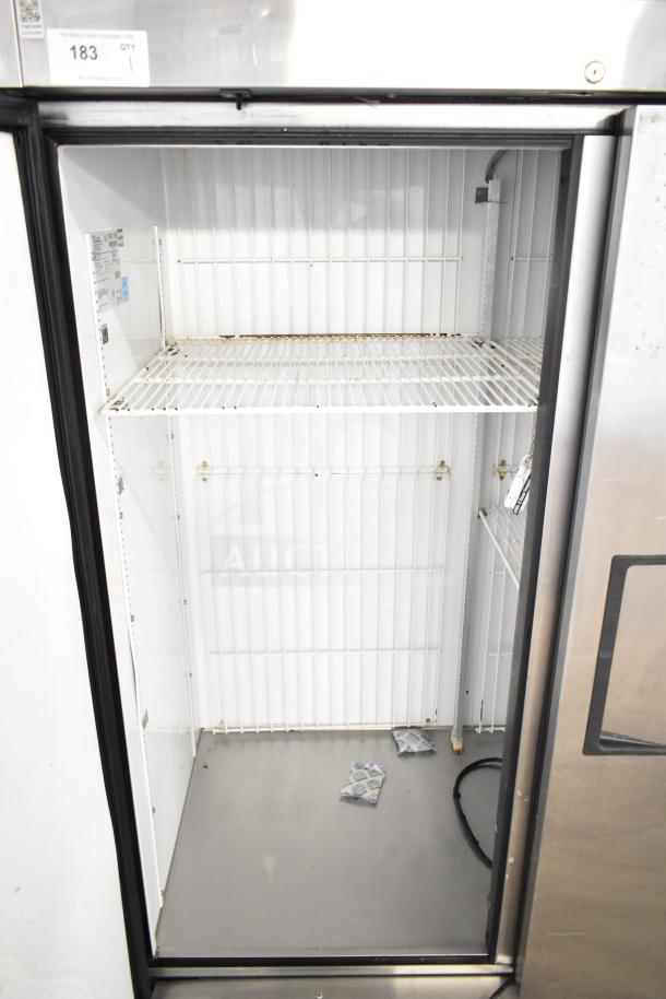 True T-49F commercial freezer, two-door, reach-in model, 115 volts, interior shelves, visible wear.