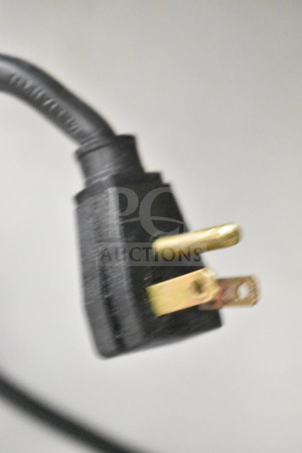 Close-up of a black power plug, part of the True T-49F Commercial 2 Door Reach In Freezer, 115 Volts, 1 Phase.