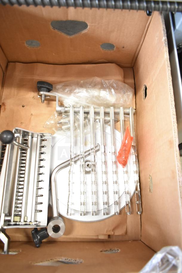 Bizerba A 404 US Commercial Meat Slicer Stacker in box, 115V, 1 Phase. Includes metal components and wrapped accessories.