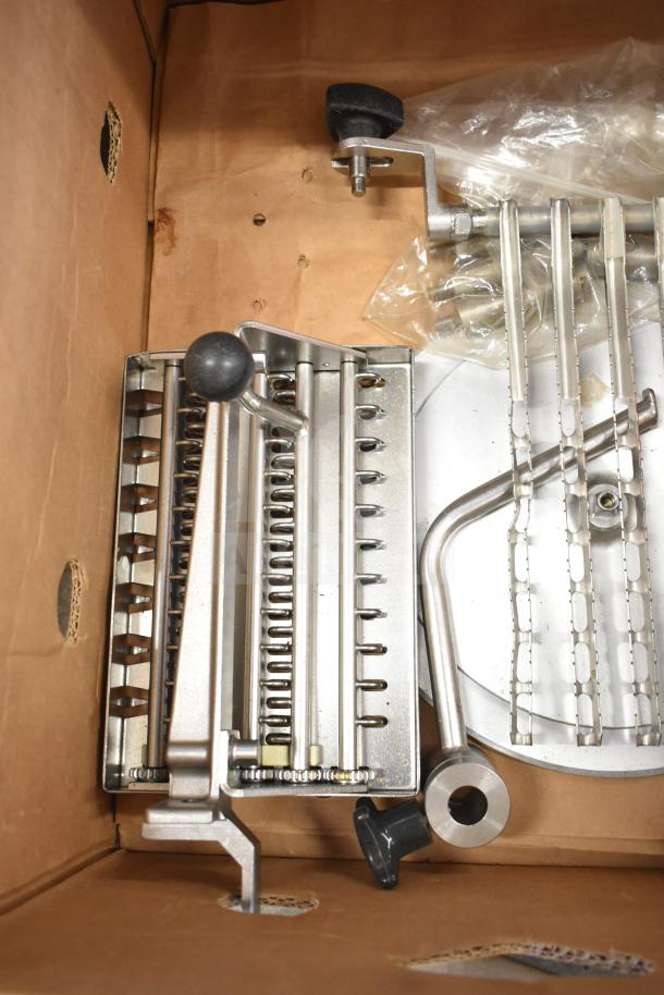 Bizerba A 404 US Commercial Meat Slicer Stacker in cardboard packaging, new condition, stainless steel components visible.