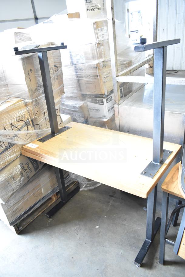 Two wooden dining height tables with metal legs, in used condition. Suitable for restaurants or home. Auction offers 2x bidding value.