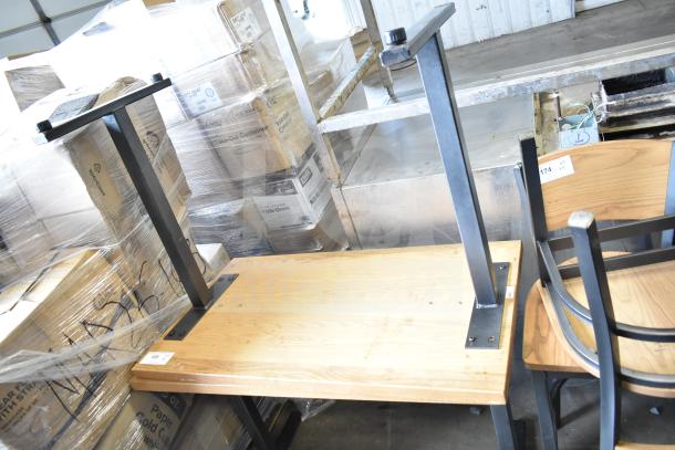 Two wooden dining height tables with sturdy metal legs, slightly used, ideal for dining settings.