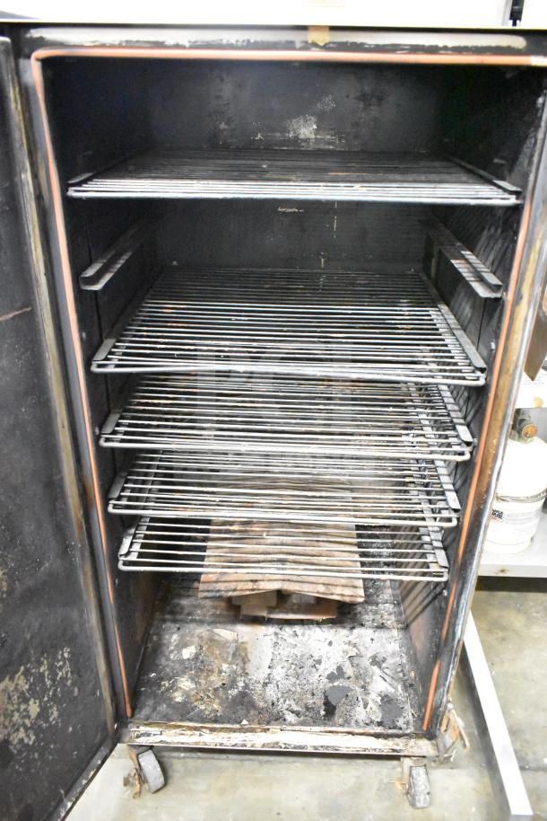 CookShack 250 Commercial Electric Smoker Cabinet on casters, 208 volts. Features multiple racks, used condition.