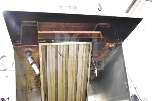BKI Commercial Hood in used condition, featuring grease buildup and wear. Includes vent fixtures and labeled BKI.